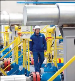  ?? MENG JING / XINHUA ?? A worker patrols the Kovykta natural gas field in Russia’s Irkutsk region in December, days before it began operations. The gas field in eastern Siberia and a new pipeline section were connected to Russia’s Power of Siberia pipeline, signaling completion of the Russian section of the China-Russia east-route natural gas pipeline.