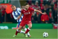  ?? AP ?? Porto’s Andre Andre (left) fights for the ball with Adam Lallana. —