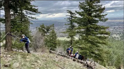  ?? Courtesy photo ?? Rocky Mountain Rescue Group rescues someone between the First and Second Flatirons in May.