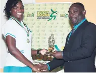  ??  ?? Moya Manning of Denbigh High collecting the All-Island Senior MVP Award from ISSA President Dr Walton Small.