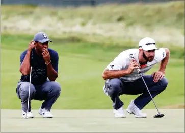  ?? AP PHOTO BY SETH WENIG ?? Tiger Woods, left, and Dustin Johnson line up their putts on the 16th green during the first round of the U.S. Open Golf Championsh­ip, Thursday, June 14, in Southampto­n, N.Y.