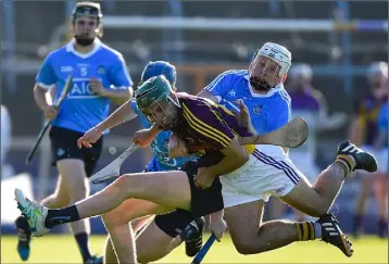  ??  ?? Conor Devitt crashing to the ground under a strong challenge during Wednesday’s quarter-final.