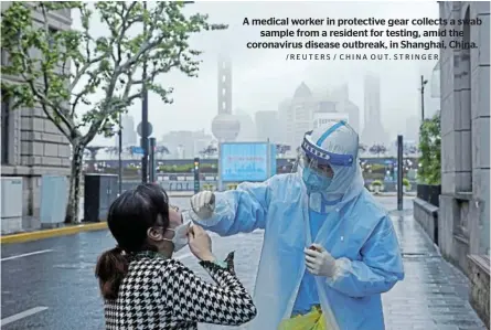  ?? /REUTERS / CHINA OUT. STRINGER ?? A medical worker in protective gear collects a swab sample from a resident for testing, amid the coronaviru­s disease outbreak, in Shanghai, China.