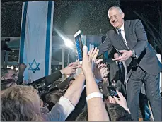  ?? AMIR LEVY/GETTY ?? Benny Gantz, leader of Blue and White party, greets supporters Sunday in Tel Aviv, Israel.