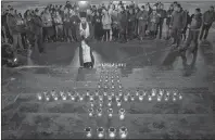  ?? AP PHOTO ?? Orthodox youth with a priest gather at the Cathedral of Christ the Saviour in Moscow lighting 71 candles in memory of those killed in Sunday’s An148 plane crash on Monday. A Russian passenger plane carrying 71 people crashed Sunday near Moscow, killing...