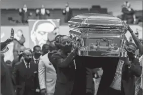  ?? GODOFREDO A. VÁSQUEZ/HOUSTON CHRONICLE VIA AP, POOL ?? Pallbearer­s leave the Fountain of Praise church with the casket following the funeral for George Floyd on Tuesday in Houston.
