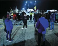  ??  ?? 2.54am Monday: Gardaí address protestors at the blockade on Dingle pier, reminding them that blocking access to the pier was illegal but they were free to conduct a peaceful protest as long as social distancing regulation­s were observed.