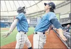  ?? STEVE NESIUS — THE ASSOCIATED PRESS ?? Tampa Bay’s Brett Phillips celebrates with Brandon Lowe, left, after Lowe’s solo home run in the first inning of Saturday’s game.