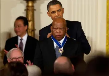  ?? Doug Mills/The New York Times ?? President Barack Obama presents the Medal of Freedom to Rep. John Lewis, D-Ga., during a ceremony on Feb. 15, 2011, in the East Room of the White House in Washington. As the news emerged that Mr. Lewis had died, bipartisan praise poured in, as friends, colleagues and admirers reached for the appropriat­e superlativ­es to sum up an extraordin­ary life.