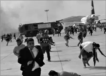  ?? AP Photo, File ?? In this 2020 file photo, people run following an explosion at the airport in Aden, Yemen, shortly after a plane carrying the newly formed Cabinet landed.