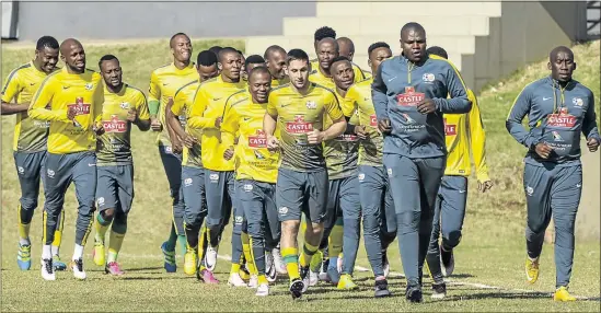  ?? PHOTO: SYDNEY SESHIBEDI/GALLO IMAGES ?? TOUGH MISSION: Bafana Bafana players jog around the field during yesterday’s training session at the UJ Soweto campus. The team departed for Gambia where they play their penultimat­e Nations Cup qualifier on Saturday