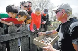  ?? Steve Helber The Associated Press file ?? Historic Jamestowne staff archaeolog­ist Lee Mcbee, right, shows artifacts to Carla Howe, of Gilmanton, N.H., left, and her children Caroline, second from left, and Grace, third from left, in April at the dig site of the Angelo slave house in Jamestown, Va.