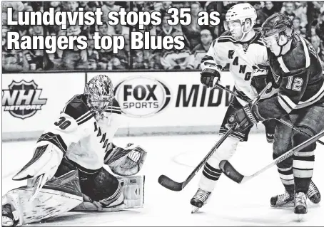  ??  ?? THE PUCK STOPS HERE: Rangers goalie Henrik Lundqvist, who had 35 saves in a 2-1 win over the Blues on Thursday night, blocks a shot by Jori Lehtera as Oscar Lindberg looks for the rebound.