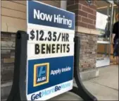  ?? ELISE AMENDOLA — THE ASSOCIATED PRESS FILE ?? A sign outside a business in Salem, N.H. says “Now Hiring.”