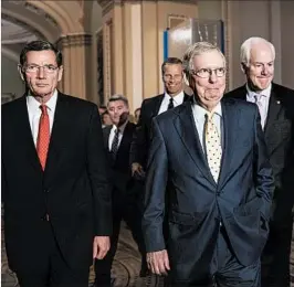  ?? J. SCOTT APPLEWHITE/AP ?? Senate Majority Leader Mitch McConnell, R-Ky., leads a group of senators, including John Barrasso, left, and John Cornyn, right, after a closed-door strategy session Tuesday.