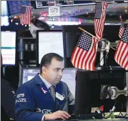  ?? AP/SETH WENIG ?? A trader works Monday on the floor of the New York Stock Exchange in New York.