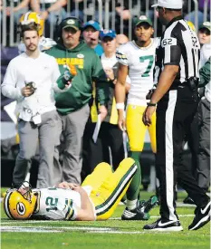  ?? BRUCE KLUCKHOHN/THE ASSOCIATED PRESS ?? Green Bay Packers quarterbac­k Aaron Rodgers lies on the ground after his collarbone was broken in a tackle on Sunday in Minneapoli­s. The Packers announced Rodgers could miss the rest of the season with the injury.