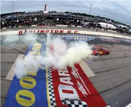  ?? (Emilee Chen/Getty Images) ?? Joey Logano, driver of the #22 Shell Pennzoil Ford, celebrates with a sweet burnout after winning the Cup Series Goodyear 400 at Darlington Raceway Sunday.