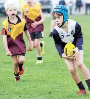 ??  ?? Samuel McDonald collects the ball for Warragul Blues against Nyora in the under 10s.