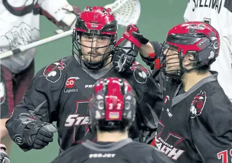  ?? GERRY KAHRMANN/POSTMEDIA NETWORK ?? St. Catharines native and Vancouver Stealth forward Corey Small celebrates a goal with teammates James Rahe and Jordan Durston against the Colorado Mammoth, the Stealth's opponent in the National Lacrosse League West Division final tonight in Langley,...