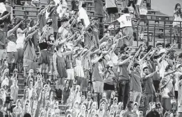  ?? Associated Press file photo ?? Fans sing “The Eyes of Texas” after a UT football game. Some students have urged UT to stop singing the song because it originated at a 1903 minstrel show.