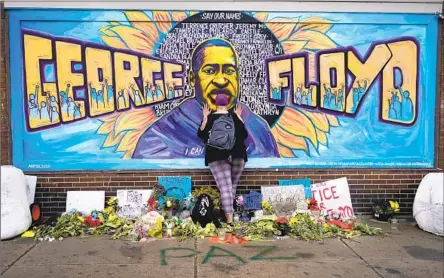  ?? IN MINNEAPOLI­S, Julio Cortez Associated Press ?? Damarra Atkins and other supporters continued to pay their respects to Floyd long after his fatal May 2020 arrest.