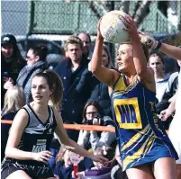  ??  ?? Ellinbank’s coach Taylah Bott gets a centre pass with Poowong’s Mieke Polman-Short.