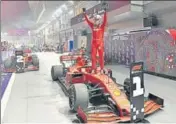  ?? AFP ?? Ferrari's Sebastian Vettel celebrates his victory atop his car at the Singapore Grand Prix on Sunday.