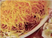  ?? CARA OWSLEY, CINCINNATI ENQUIRER ?? Cincinnati-style chili is covered with a mound of shredded cheddar.