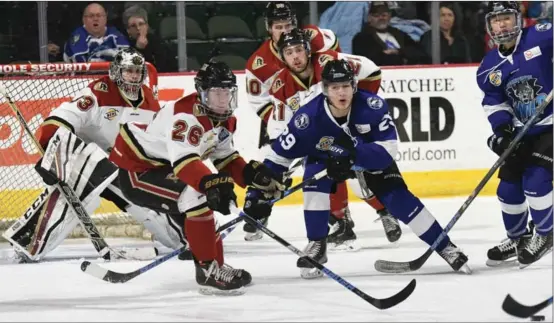  ?? ROSS ALMAN/Digital Media Northwest ?? The West Kelowna Warriors (in white) won the Friday night game in Wenatchee against the Wild by a 5-4 score in overtime.