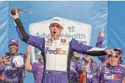  ?? ?? Denny Hamlin celebrates in victory lane after winning the NASCAR Cup Series Advent Health 400 at Kansas Speedway on Sunday.