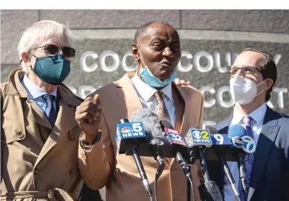  ?? PAT NABONG/SUN-TIMES ?? Jackie Wilson, center, flanked by his attorneys Flint Taylor, left, and Elliot Slosar, right, speaks to the press outside Cook County Criminal Court after a hearing about prosecutor­ial misconduct on Oct. 2, 2020. Wilson is a torture survivor of late Chicago Police Cmdr. Jon Burge.