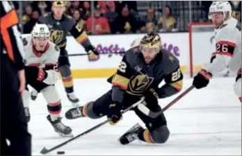  ?? (AP PHOTO/STEVE MARCUS) ?? Vegas Golden Knights right wing Michael Amadio (22) is tripped between Ottawa Senators left wing Parker Kelly (27) and defenseman Erik Brannstrom (26) during the second period of Sunday’s game, in Las Vegas. Brannstrom was penalized on the play.