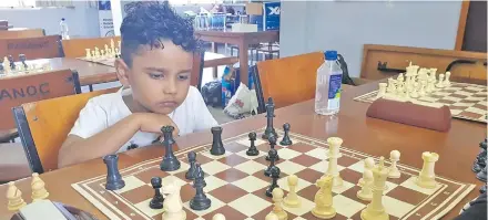  ?? Photo: Fiji Chess Federation. ?? Yash Prasad, 5, ponders on his next move during the D Gokals Fiji Day Open Chess Championsh­ip in Suva.