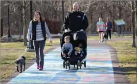  ?? SUBMITTED PHOTO ?? A family enjoys a stroll on the mosaic painted on the Schuylkill river Trail in Pottstown’s Riverfront Park.