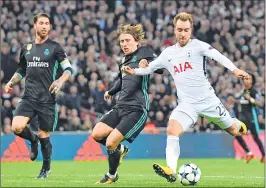  ??  ?? Tottenham Hotspur's Danish midfielder Christian Eriksen (R) shoots past Real Madrid's Croatian midfielder Luka Modric (C) to score their third goal during the Champions League Group H match at Wembley Stadium in London.