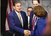  ?? TOM BRENNER/NEW YORK TIMES ?? Sen. Joe Manchin (left), D-W.Va., speaking Wednesday with Sen. Dianne Feinstein, D-Calif., won his primary Tuesday, but faces a tough fall race against Republican state Attorney General Patrick Morrisey.