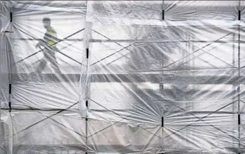  ?? Steph Chambers/Post-Gazette ?? A Continenta­l Building Co. constructi­on worker walks through a structure on North Shore Drive that will eventually house Ben Roethlisbe­rger’s restaurant, North Shore Seven.