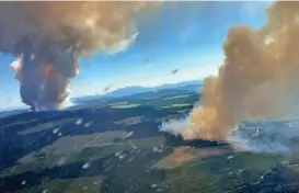  ?? (AFP) ?? This file photo shows two plumes of smoke from wildfires in Long Loch and Derickson Lake areas of Canada's westernmos­t province of British Columbia, on June 30