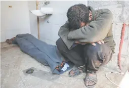  ?? ?? RISING DEATH TOLL – A man mourns next to the shrouded body of a loved one killed during Israeli bombardmen­t, at Al-aqsa hospital in Deir el-balah in central Gaza on Feb. 28, 2024. (AFP)