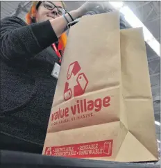  ?? SARA ERICSSON/SALTWIRE NETWORK ?? Value Village store manager Reg Chitty says his New Minas store has been using paper bags in lieu of plastic since last August, and the change has been a popular with customers.