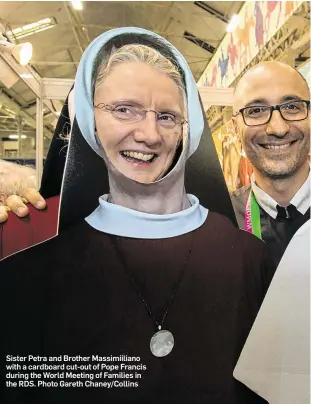  ??  ?? Sister Petra and Brother Massimiili­ano with a cardboard cut-out of Pope Francis during the World Meeting of Families in the RDS. Photo Gareth Chaney/Collins