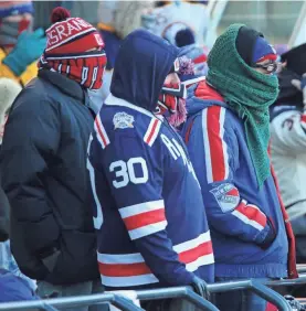  ?? DANNY WILD/USA TODAY SPORTS ?? Fans brave Monday’s Winter Classic outdoor hockey game between the New York Rangers and the Buffalo Sabres at Citi Field in Queens, N.Y. Despite the freeze, New Year’s events in many cities went on.