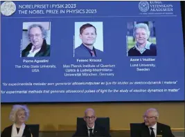  ?? ANDERS WIKLUND — FOR THE ASSOCIATED PRESS ?? Hans Ellegren, permanent secretary of the Royal Academy of Sciences, together with members Eva Olsson, left, and Mats Larsson announces the winner of the 2023Nobel Prize in physics in Stockholm on Tuesday.