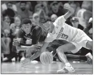  ?? AP/MICHAEL WYKE ?? Cincinnati forward Trevon Scott (left) and Houston guard Dejon Jarreau (13) scramble for the ball in the Cougars’ 65-58 victory over the Bearcats on Sunday.