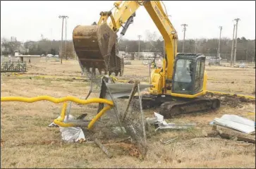  ?? The Sentinel-Record/Richard Rasmussen ?? PREP WORK: An Ervan Slaight Demolition and Excavation employee tears down fencing and dugouts with a backhoe Tuesday at the future site of the Majestic Park Baseball Complex, located at the former site of the Boys &amp; Girls Club of Hot Springs. The site preparatio­n is fully funded by a grant from the Oaklawn Foundation.