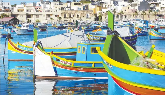  ?? GRETCHEN STRAUCH ?? According to local tradition, the colours of these Maltese fishing boats that dot the coastline represent a fisherman’s home village.