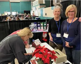  ?? ?? Medicine Hat Women’s Shelter Society volunteers Cindy Strain and Susan Baird help with the fundraisin­g raffle booth at the annual Fall Into Christmas show. Assisting with this annual fundraiser is just one of many ways volunteers help make a difference with MHWSS.