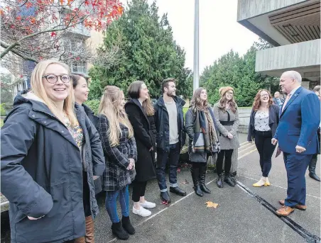  ??  ?? Premier John Horgan, right, with University of Victoria students at a student housing project announceme­nt on Nov. 15. Two older residences will be replaced by two bigger, taller buildings.