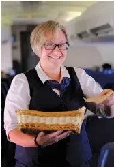  ?? © SIMONBLAKE­SLEY.CA ?? AN AIR NORTH, YUKON'S AIRLINE FLIGHT ATTENDANT SERVING THE AIRLINE'S FAMOUS WARM COOKIES.